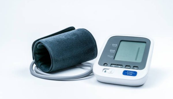 Automatic portable blood pressure machine with arm cuff isolated on white with copy space, studio shot. Blank display without figurs.