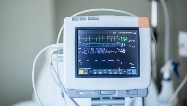 Medical vital signs monitor instrument in a hospital. This health care device displays and monitors heart rate and oxygen levels in hospital patients